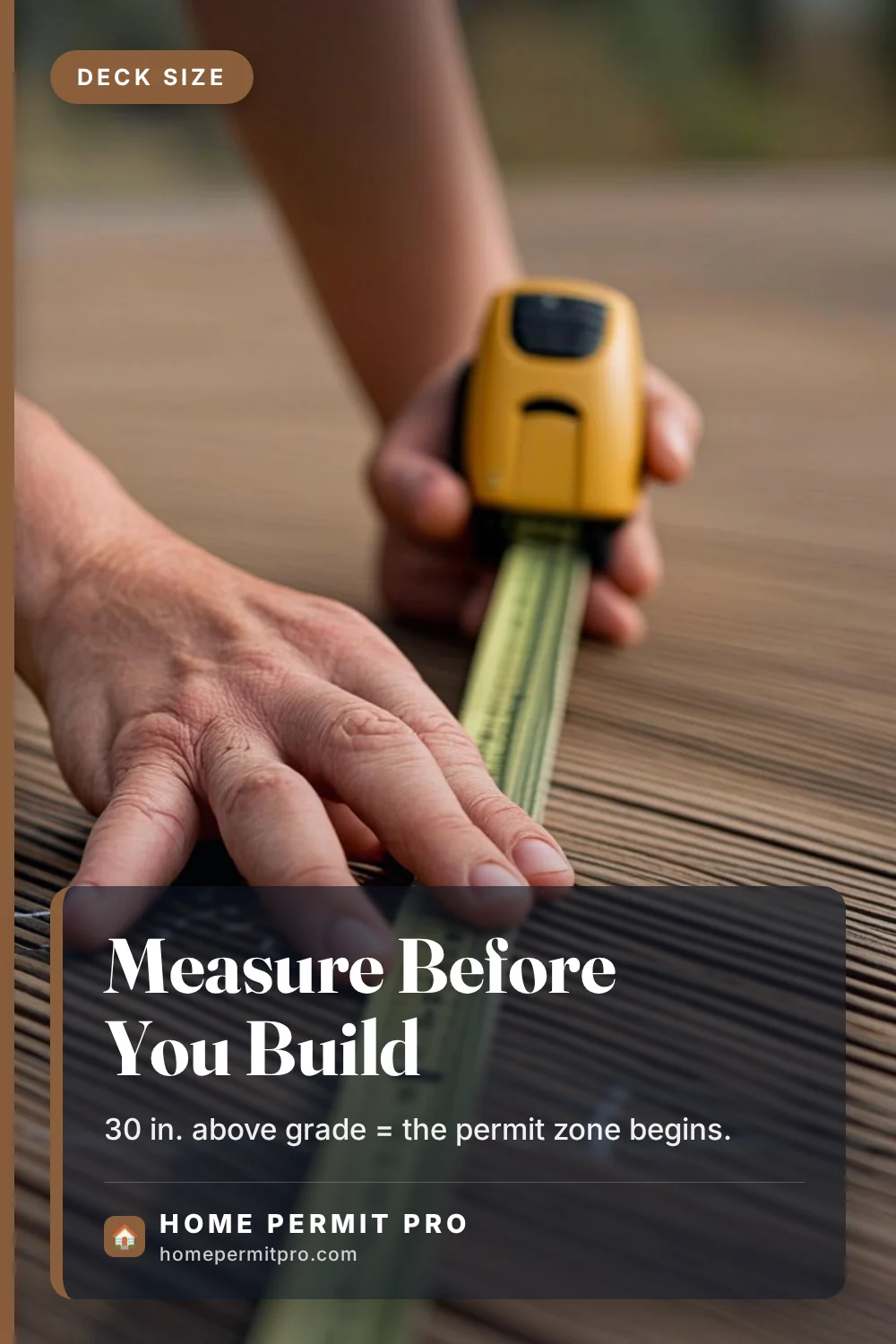 Tape measure extended across wooden deck boards to measure deck size